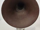 a brown hat sitting on top of a wooden tripod