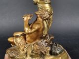 an image of a statue of a woman sitting on a marble base
