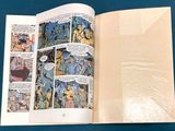 a comic book opened to show a page of comics
