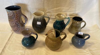 many different types of vases sitting on a table