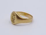 a close up of a gold signet ring on a white surface