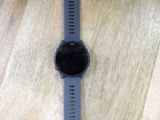a close up of a watch on a wooden floor