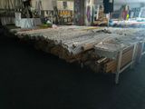 many rolls of fabric sitting on a table in a store