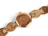 an image of a close up of a wrist watch on a white surface