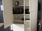 a white cabinet with a door open in a room