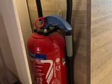 a fire extinguisor attached to a wall in a room