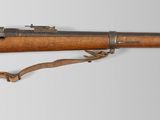 an old rifle with a wooden barrel on a white background