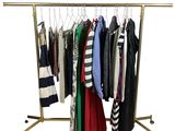 clothes hanging on a clothes rack on a white background