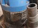 an image of a water pump and a hose on the floor