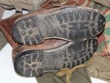 a pair of shoes sitting on top of a pile of clothes
