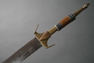 a close up of a knife with a wooden handle