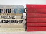 several books stacked on top of each other on a white surface