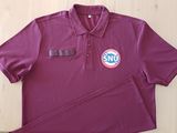 a close up of a purple polo shirt with a small patch on the chest