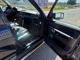 a black car with its door open on the street