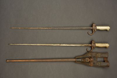 three different types of weapons are displayed on a gray surface