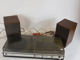 two speakers on top of a stereo system on a white surface