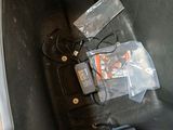 an image of a car seat with a bunch of items in it