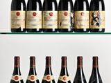 several bottles of wine are lined up on a glass shelf