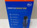 a box of a blue microphone sitting on top of a table