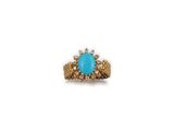 a gold and turquoise stone ring with pearls