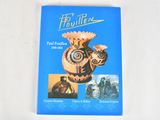 a blue book with a picture of a vase on it
