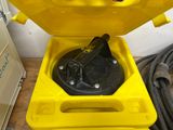 a yellow box with a black lid on a table