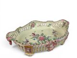 a decorative bowl with flowers on it on a white surface