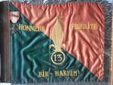 flags are displayed on a table in a room with a table cloth