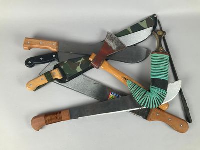 four different types of knives and a brush on a table