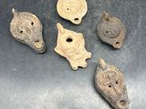 four pieces of ancient artifacts sitting on top of a metal surface