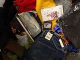 a pile of clothes and other items on the floor