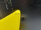a yellow piece of metal on the side of a bus
