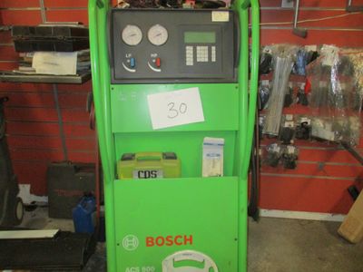 a green machine that is sitting in a garage