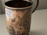 a cup that is sitting on a table with a tag on it
