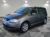 the grey van is parked on a checkered floor in the garage