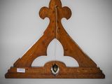 an old wooden clock hanging on a wall in a room