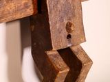 a wooden sculpture of a man holding a piece of wood