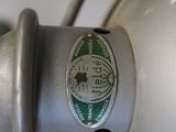 a close up of a lamp with a green label on it