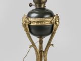 an image of a black and gold lamp on a white background