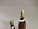 two bottles of wine sitting next to each other on a table