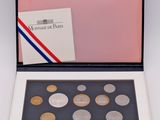 a box of coins with a card and envelope in it
