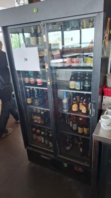 a refrigerator that has a lot of bottles of beer in it