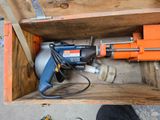 a drill in a wooden box with tools inside of it