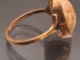 an image of a gold ring with a stone in the middle