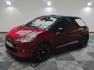 the red citrole is parked on a checkered floor