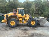 a picture of a yellow construction vehicle parked in a parking lot