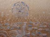 a picture of a very old embroidered cloth with birds and flowers on it