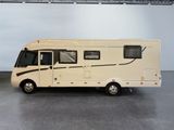 an image of a small motor home in a garage