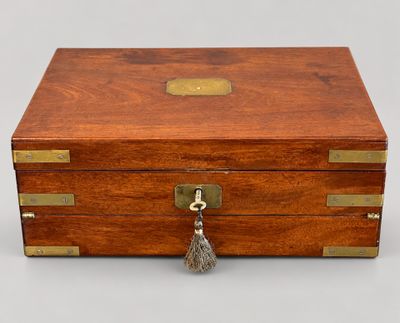an old wooden box with a tassel on top of it
