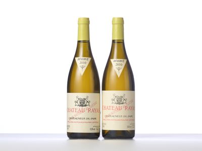 two bottles of white wine sitting next to each other on a table